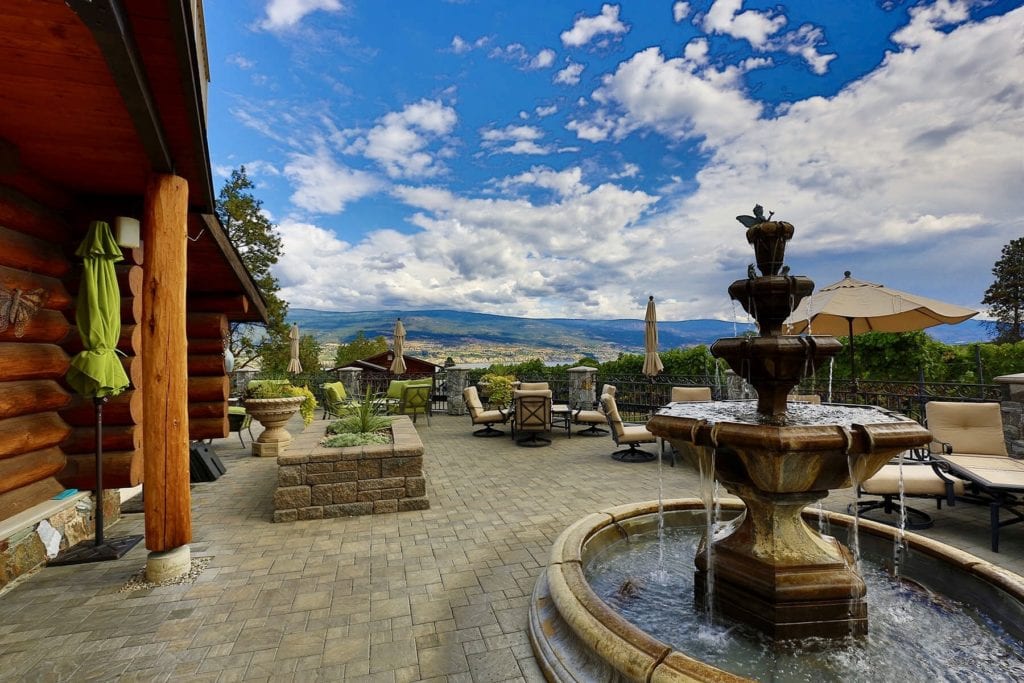 Winery patio with a stone fountain overlooking Okanagan Lake